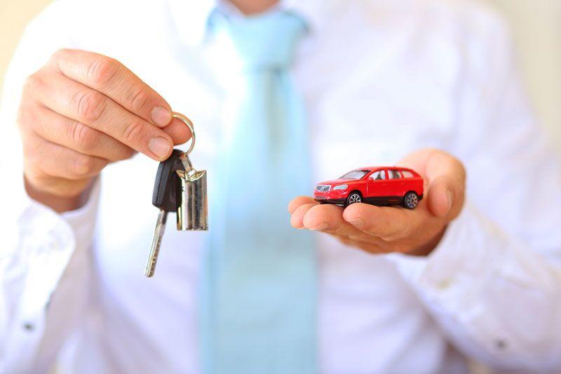 man holding car keys and toy car, auto insurance for non-licensed car owners